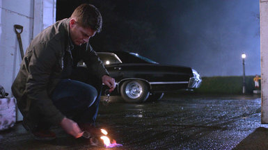 Dean smokes the glasses over the burning holy oil.